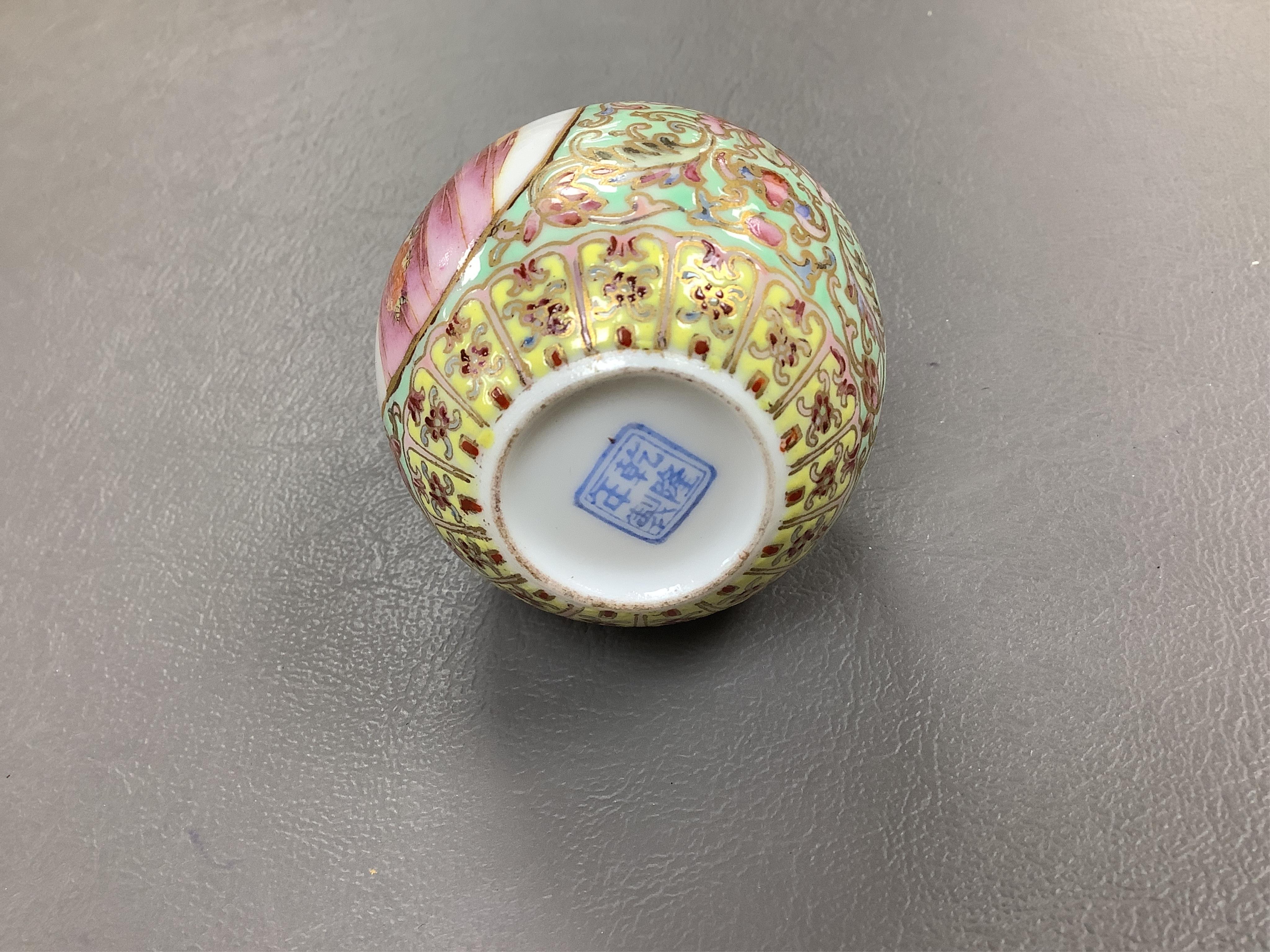 A Chinese enamelled white glass snuff bottle, a blue and white bird feeder and a famille rose vase, the first 9cm
